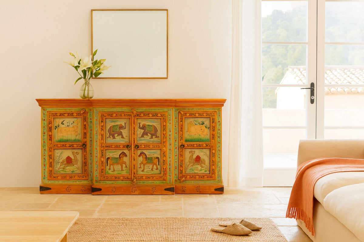 Decorative wooden sideboard with animal illustrations in a living room setting.
