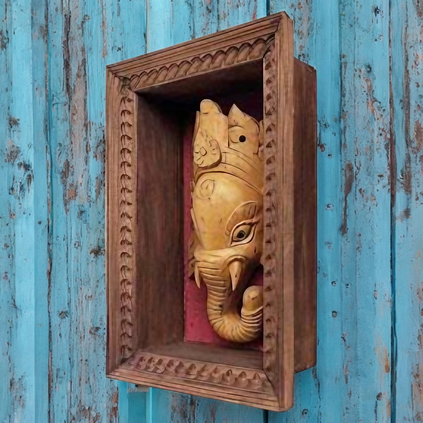Wooden carved Ganesha wall decor in a handcrafted frame, featuring traditional Indian design, ideal for pooja rooms and antique home decor.
