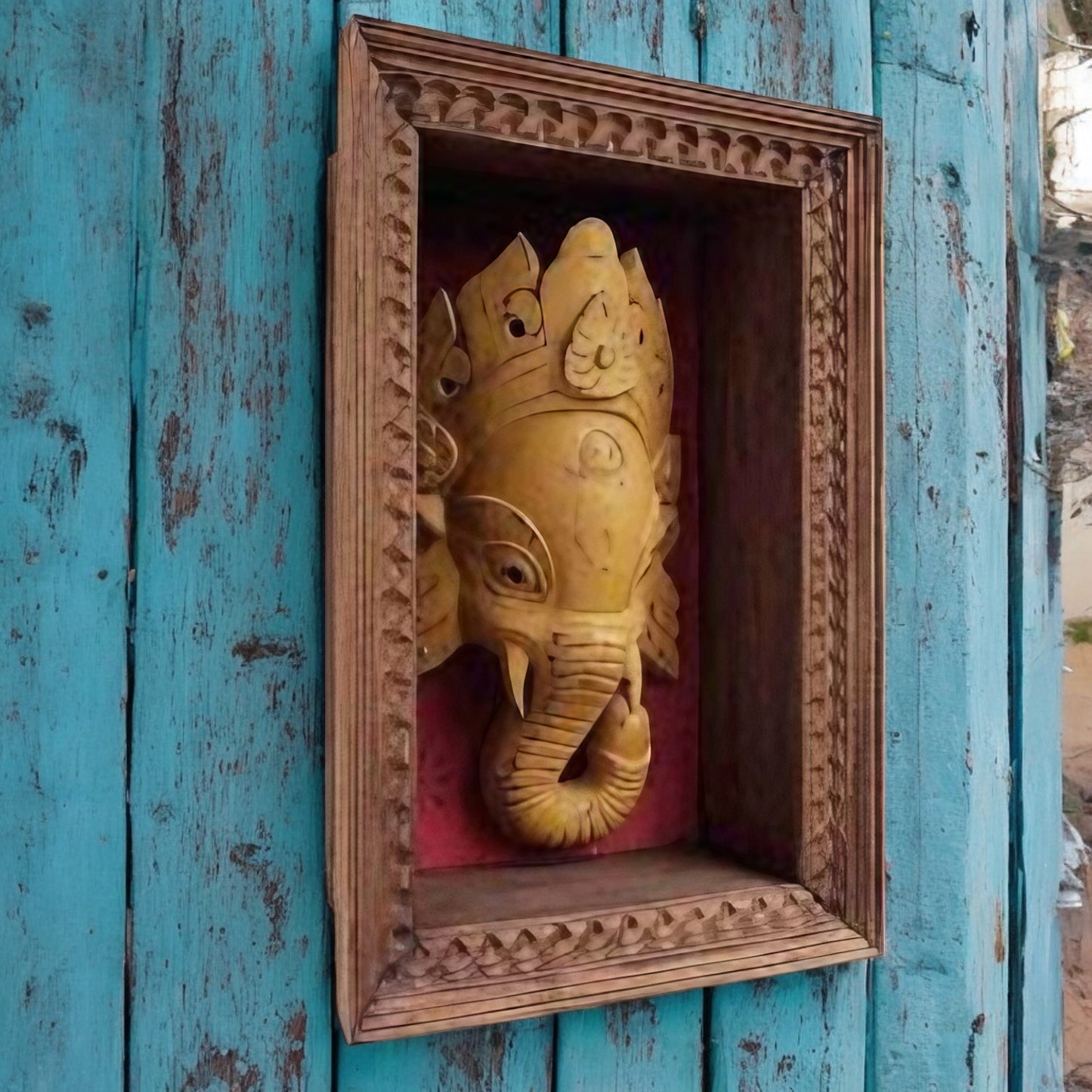 Wooden carved Ganesha wall decor in a handcrafted frame, featuring traditional Indian design, ideal for pooja rooms and antique home decor.