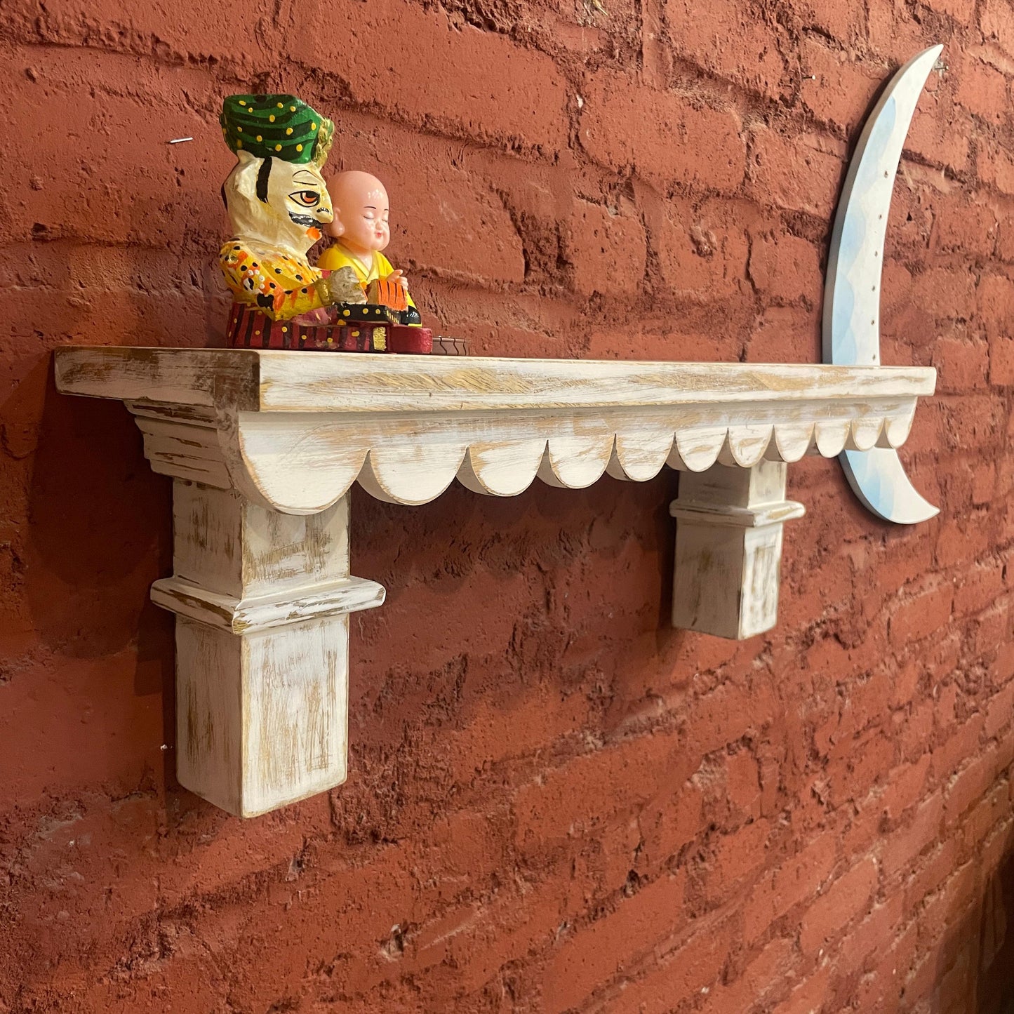 Shabby whitewashed carved wall shelves with an elegant design inspired by vintage decor. These wooden shelves function as a wishing chair-inspired decorative piece or a functional bookshelf, adding a rustic and timeless vibe to any home setting, from boho to farmhouse styles
