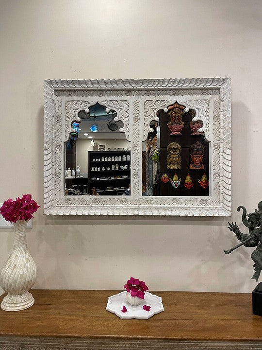 Antique brass-framed Jharokha mirror with detailed carvings, suitable for enhancing vintage bathroom setups or gallery walls