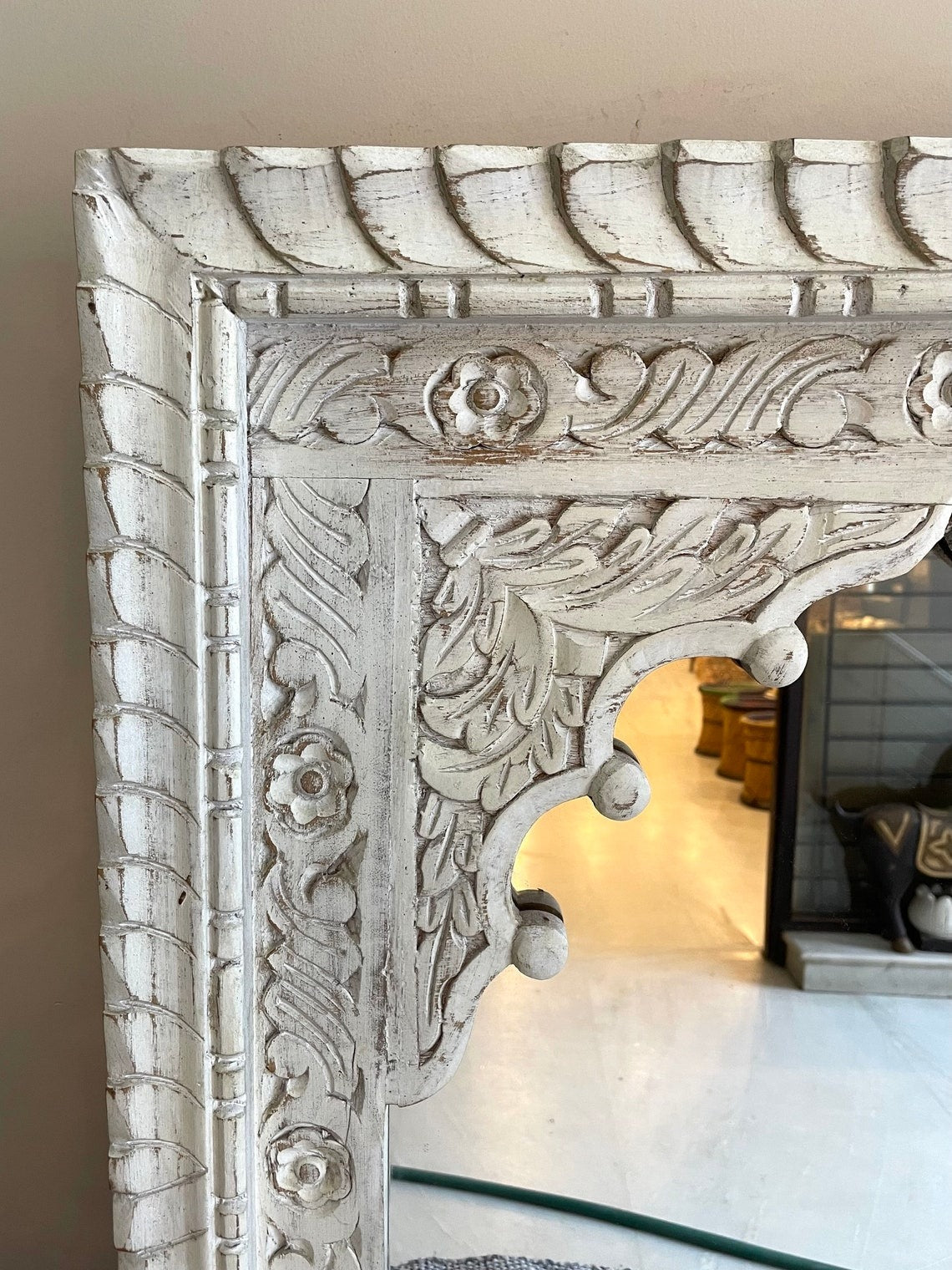 Framed mirror wall featuring a large black jharokha arch mirror, adding depth and style to contemporary or vintage spaces