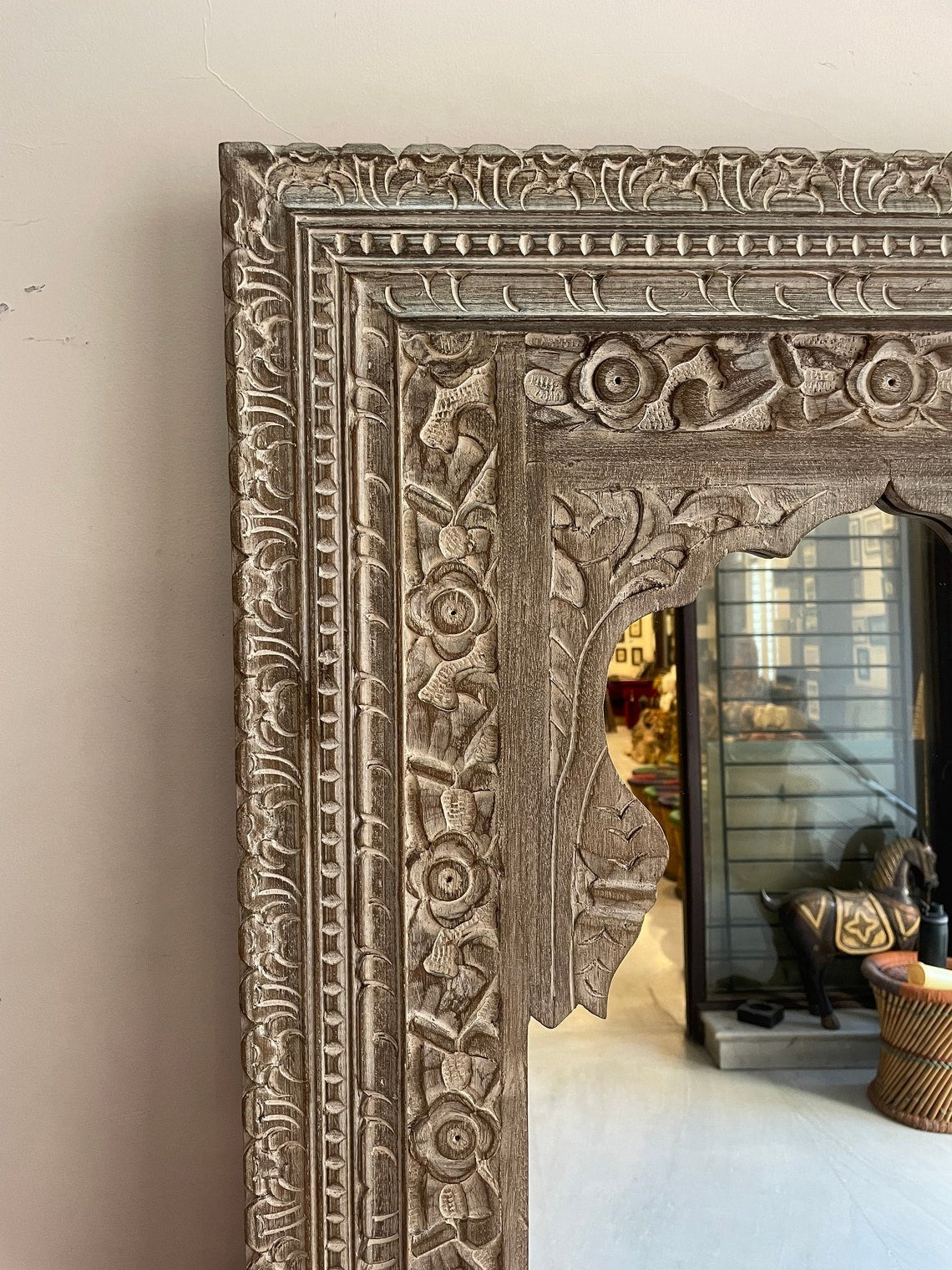 Carved mirror framed in a gold frame mirror design, showcasing large vintage mirror aesthetics with a jharokha-inspired touch for classic interiors."
"Stunning vintage floor mirror with a jharokha mirror frame, custom-sized for living rooms, dressing areas, or as an antique standing mirror centerpiece."
"Antique wall mirror featuring a jharokha mirror frame, large vintage mirror styling, and gold-framed mirror details for retro and modern interiors."
"Black framed mirror with a jharokha-inspired design, off