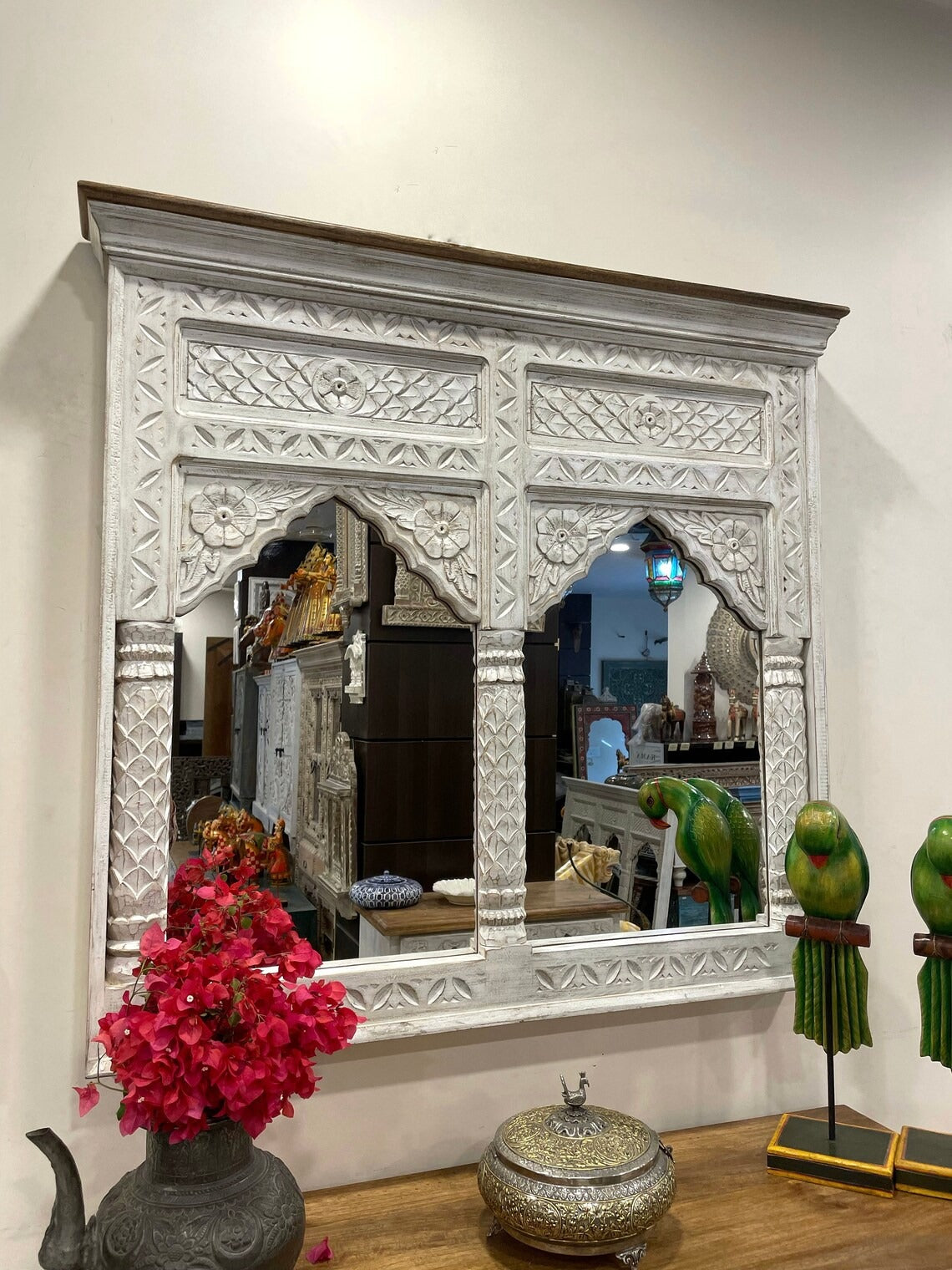Antique wall mirror encased in a delicately carved jharokha frame, offering a perfect combination of Indian heritage and modern vintage wall decor