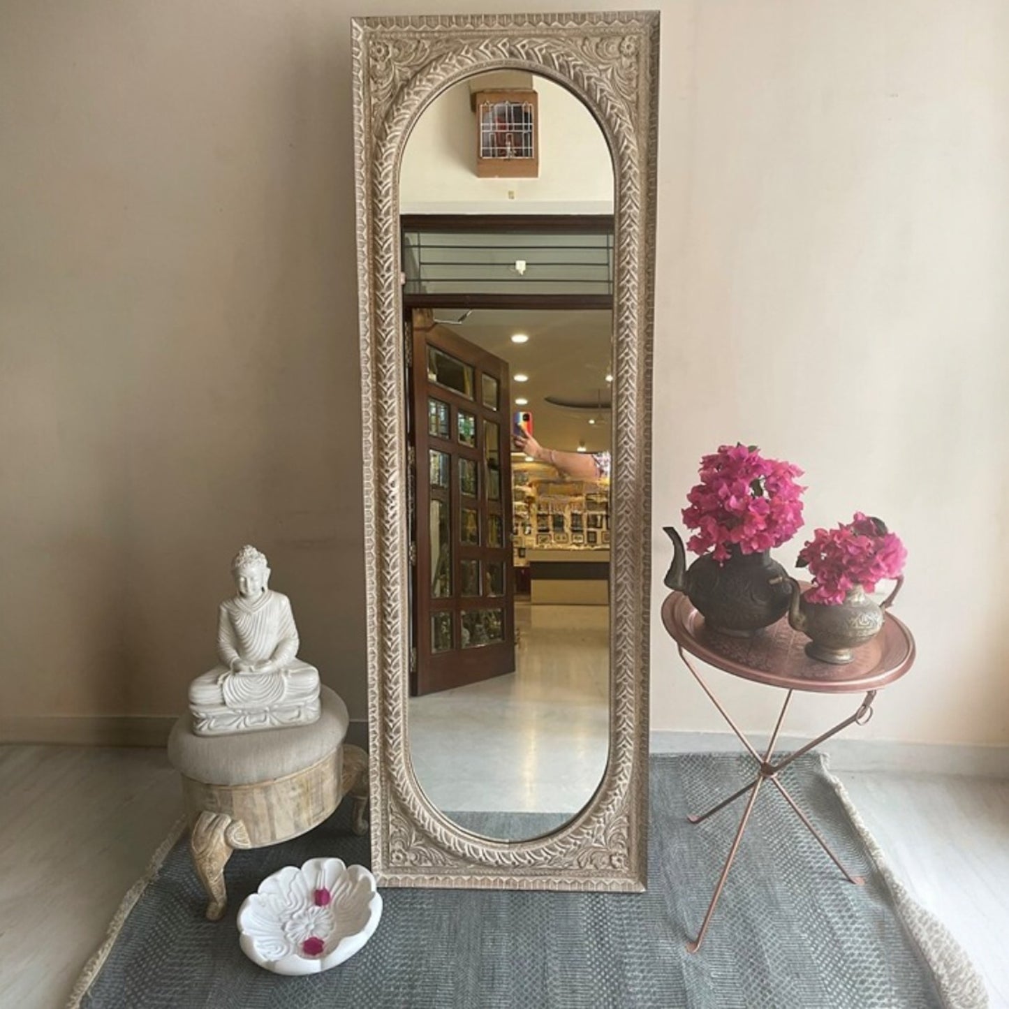 Large vintage mirror framed in a stunning jharokha mirror frame with ornate, traditional wood carvings. This antique mirror adds character and charm to any vintage-inspired home, from bathrooms to living rooms. The mirror is perfect for those looking to add a statement piece to their retro wall art collection