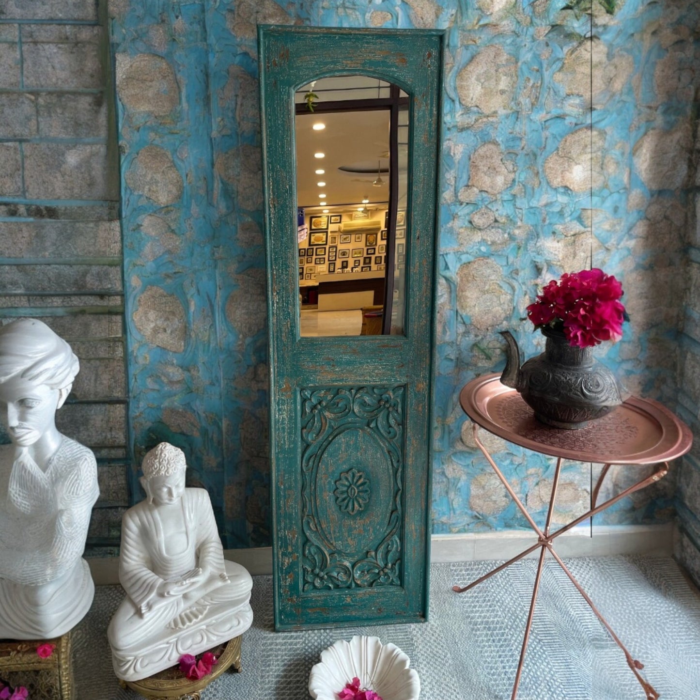 An antique brass mirror with a carved jharokha mirror frame, featuring a large vintage mirror for luxurious and elegant wall decor.