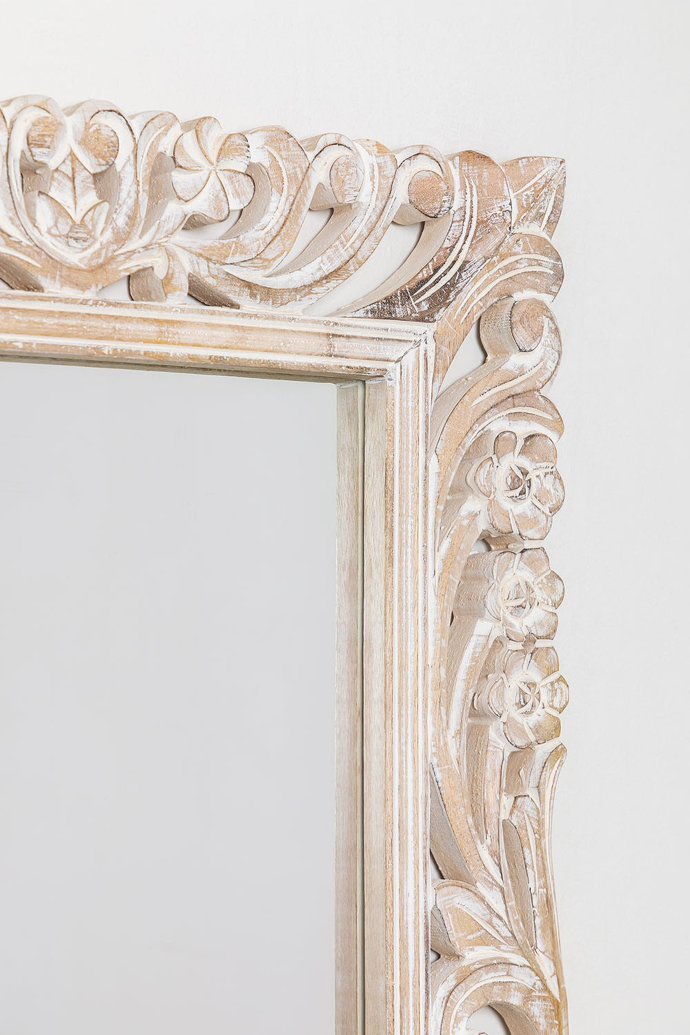 Big vintage mirror framed with detailed carvings and a distressed wood finish, designed to complement antique wall decor in modern or traditional spaces