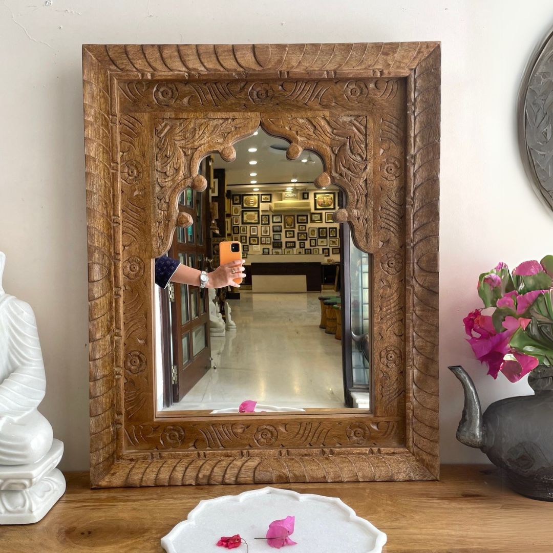 Beautiful jharokha mirror frame with intricate carvings and a vintage oval wood mirror, ideal for Victorian-style interiors.