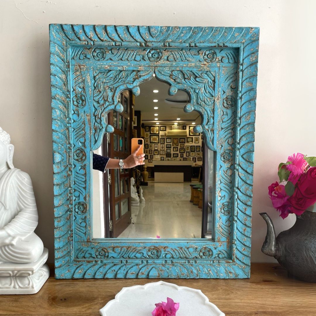 "Antique gold mirror with a jharokha-inspired design, blending elegance with classic Indian wall decor traditions.