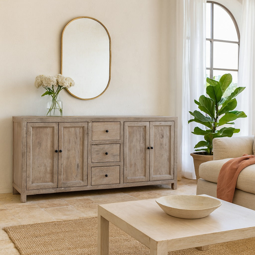 Living room with wooden sideboard, coffee table, and decorative elements.