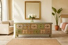 Wooden sideboard with decorative items in a living room setting