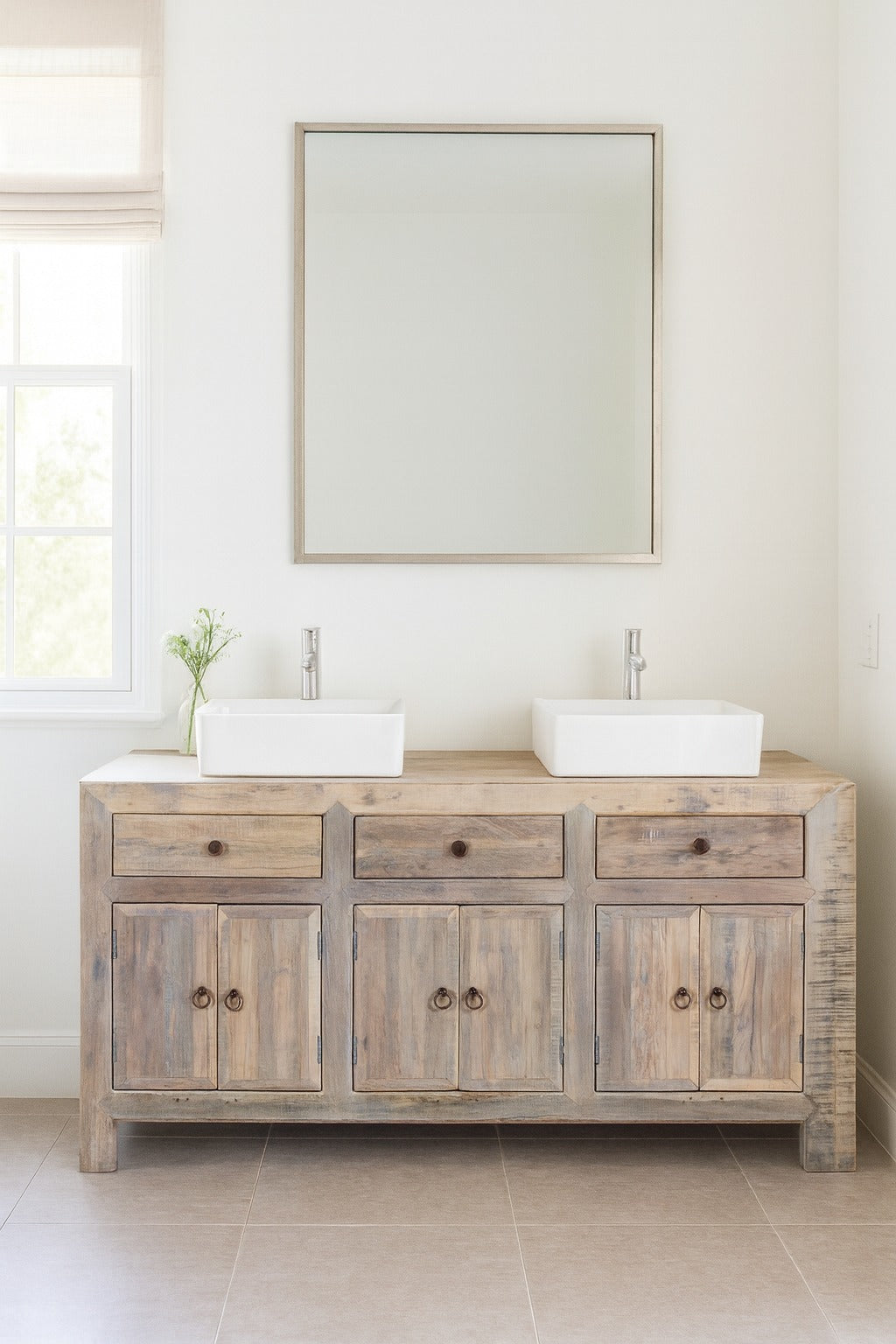 Bathroom vanity with wooden cabinet, two white sinks, and a large mirror above.