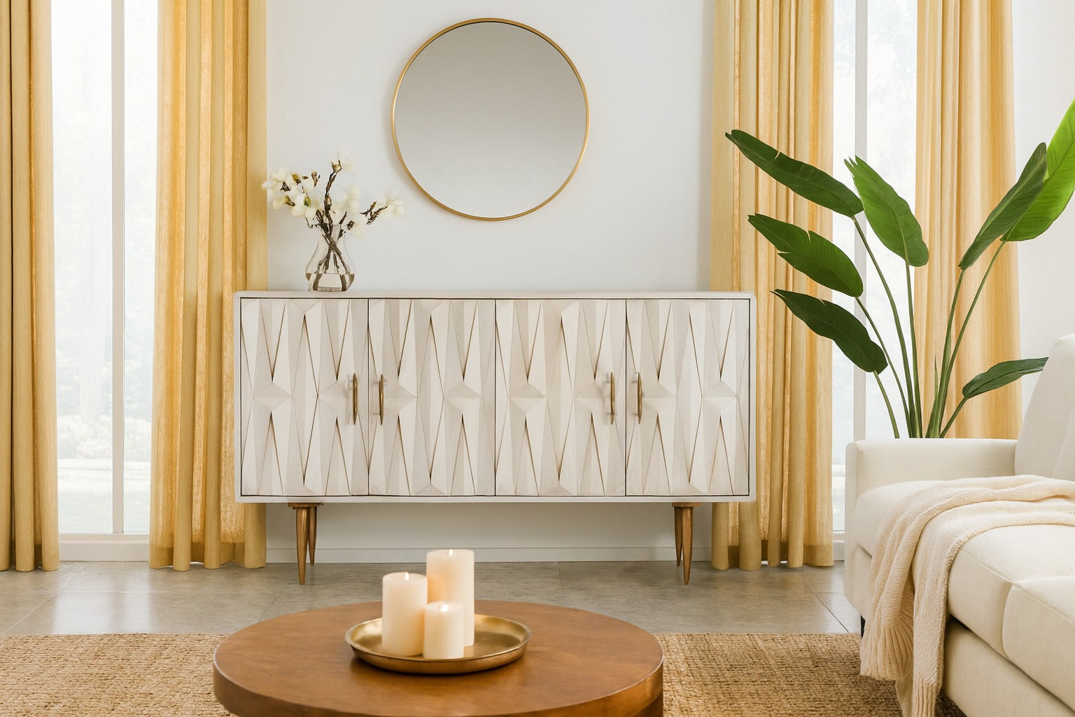 Modern living room with a decorative cabinet, round mirror, and candles on a coffee table.