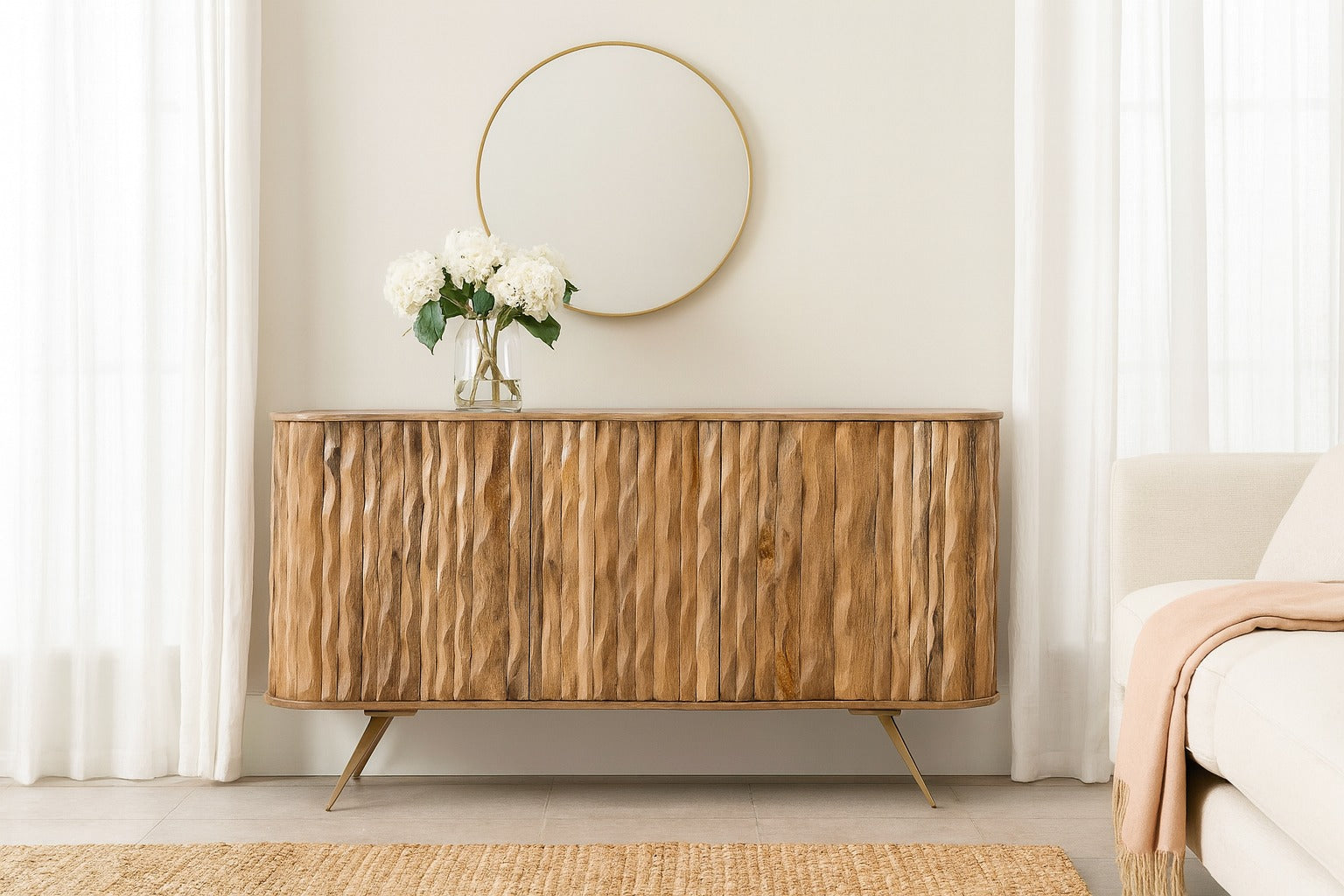 Wooden sideboard with a round mirror above it in a living room setting.