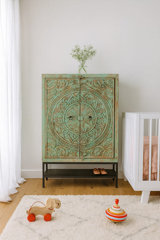 Nursery room with decorative cabinet, crib, and toys on a light wood floor.