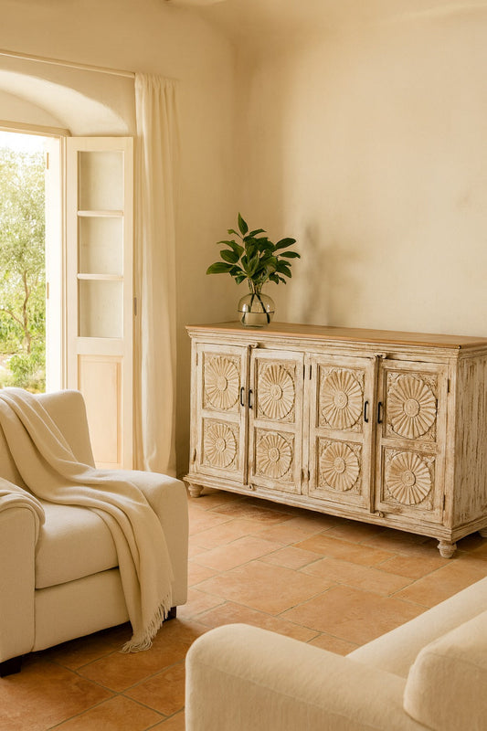Living room with a wooden sideboard, armchair, and plant