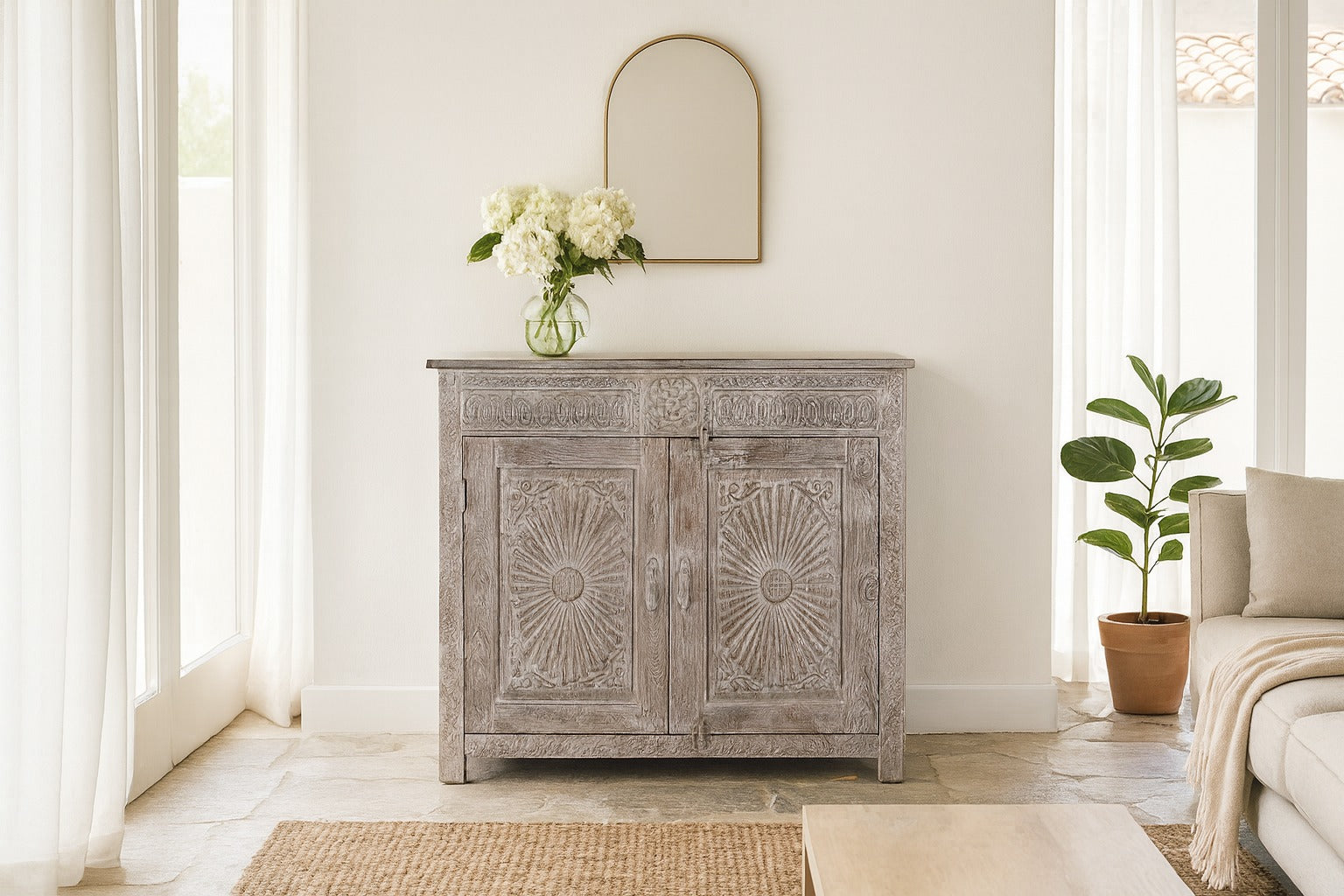 Wooden cabinet with decorative sunburst pattern in a bright room with a mirror and plant.