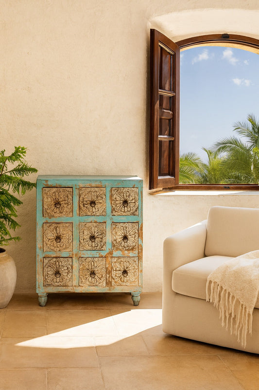 Decorative chest of drawers in a room with a window and sofa