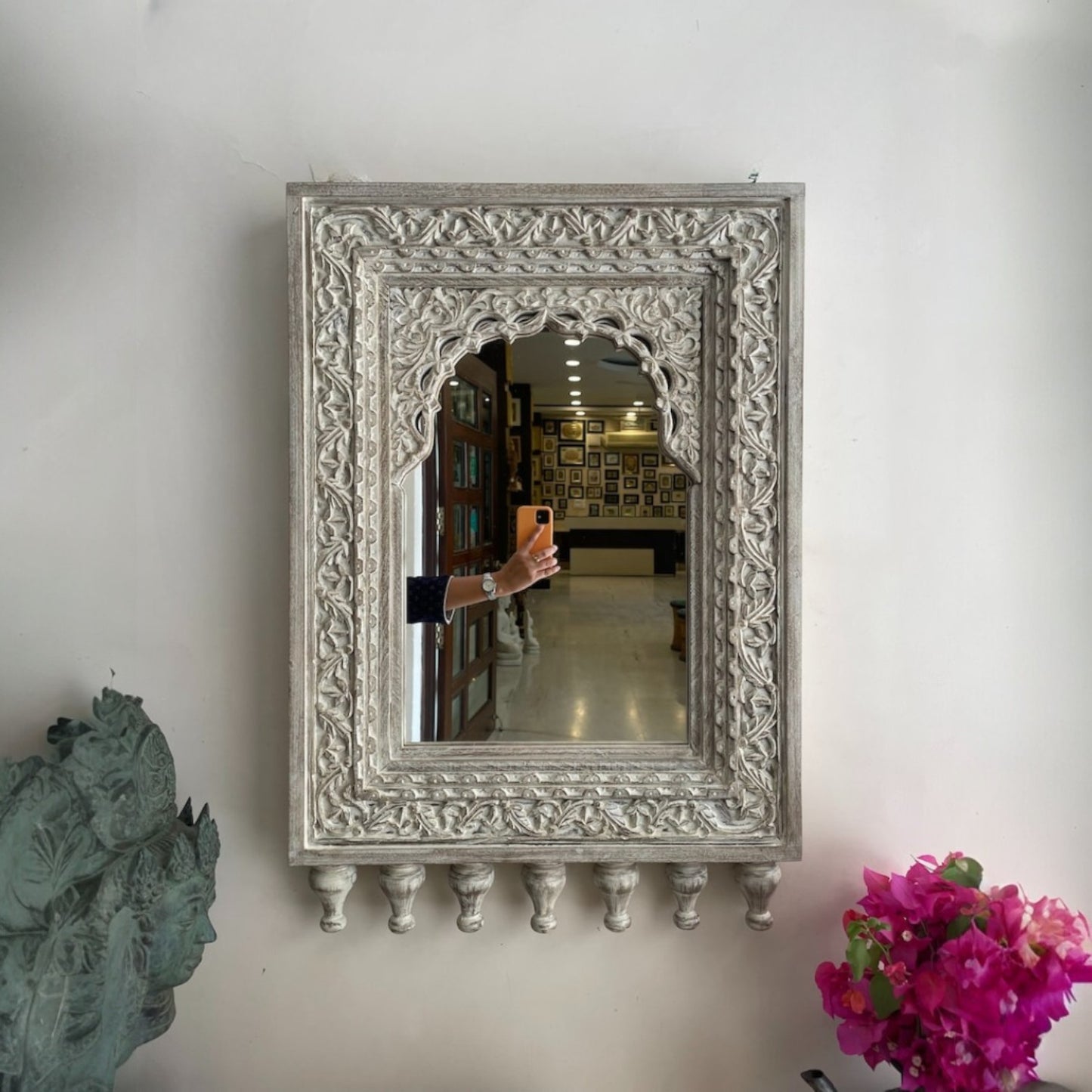 Antique brass-framed Jharokha mirror with bold carved detailing, an ideal centerpiece for vintage-inspired dressing areas or entryways
