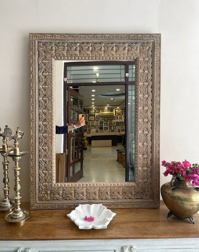 Antique dressing table with a mirror framed by a Jharokha-style design, crafted from carved wood to create a luxurious vintage look for bedrooms or hallways.