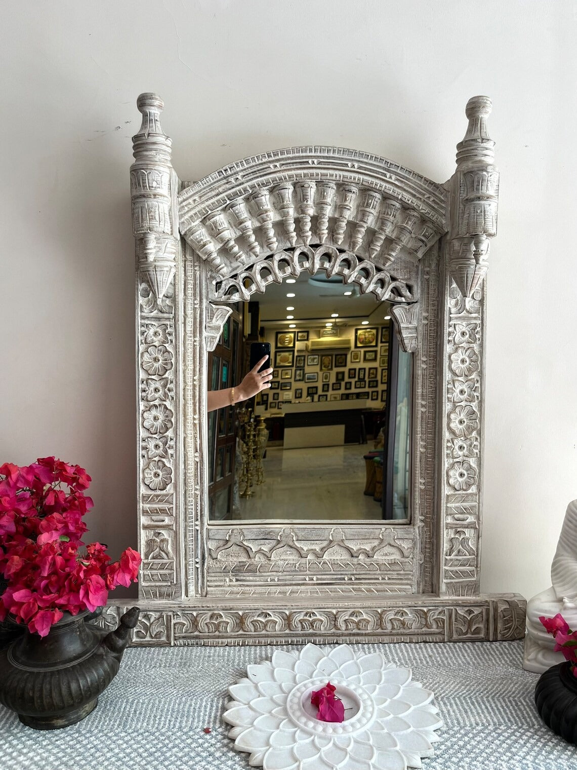 Unique oval wood mirror framed in a Jharokha-inspired design, bringing a touch of traditional Indian craftsmanship to modern and retro wall art settings