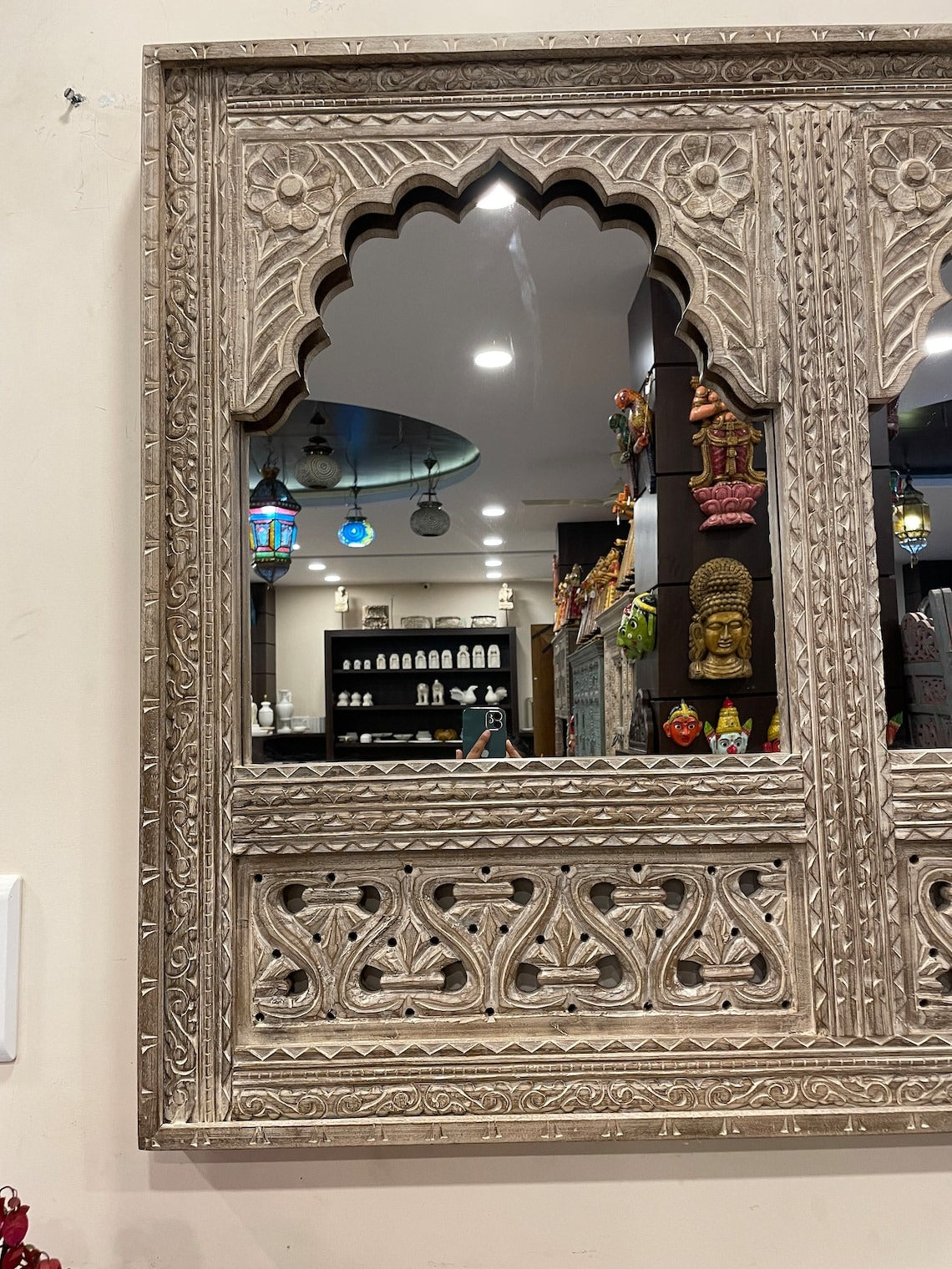 Handcrafted Jharokha mirror frame with gold accents, combining antique aesthetics with a luxurious touch for living rooms.