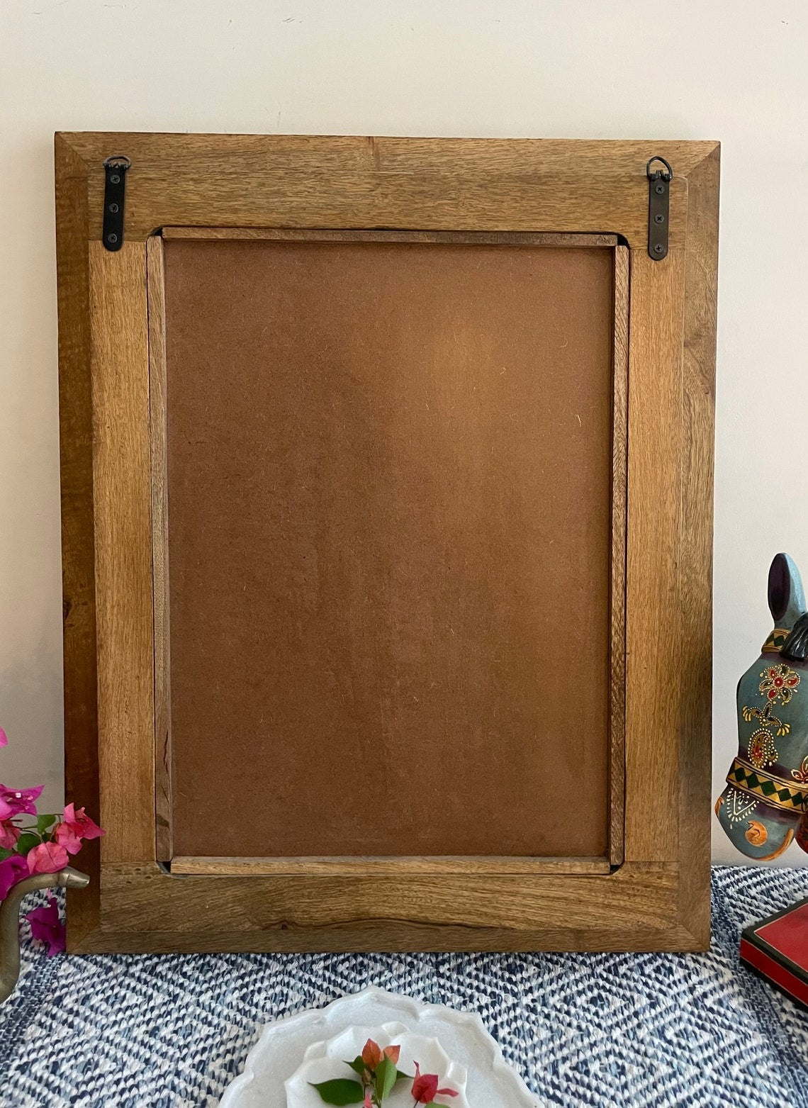 An antique brass mirror in a unique jharokha mirror frame, combining traditional Indian designs with functional decor